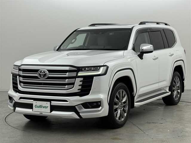 トヨタ ランドクルーザー ZX 福岡県 2023(令5)年 2.2万km プレシャスホワイトパール トヨタメーカー純正12.3インチナビ/【AM/FM/CD/DVD/BT/USB/SD/フルセグ/HDMI】/Apple CarPlay/AndroidAuto/パワーバックドア/パノラミックビューモニター（全方位カメラ）/電動サンルーフ/ビルトインETC2.0/前後ドライブレコーダー【TZ-D215W】/純正11型左右独立リアエンターテインメントシステム/トヨタセーフティセンス/・レーダークルーズコントロール/・プリクラッシュセーフティ/・ロードサインアシスト/・アダプティブハイビームシステム/・ブラインドスポットモニター/・パーキングサポートブレーキ/・リヤクロストラフィックアラート/マルチテレインモニター/おむかえ照明機能付LEDクリアランスランプ/木目調/革巻きコンビステアリング/ステアリングヒーター/ベージュ本革シート/前席パワーシート/前席/2列目ベンチレーション付快適温熱シート/3列目電動格納シート/モデリスタエアロ(F/R/フェンダー)/純正20インチアルミホイール/JBLサウンドシステム/AC100V電源/HUD/クールボックス/電動リヤデフロック/シーケンシャルウィンカー/盗難防止システム/純正トノカバー