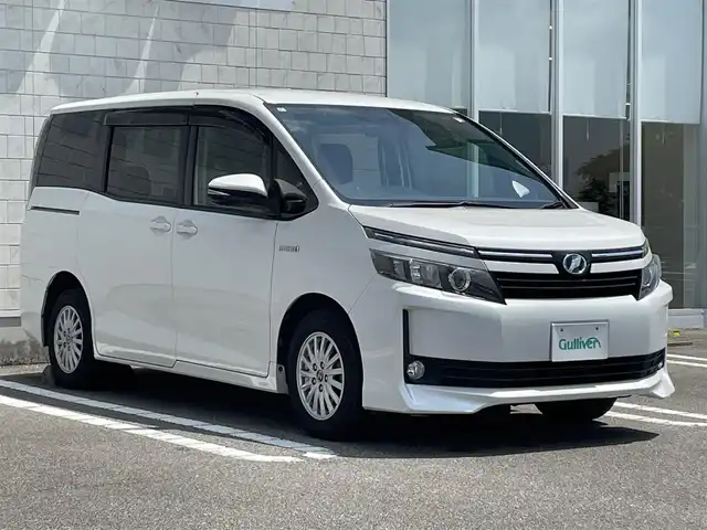 トヨタ ヴォクシー ハイブリッド V 宮崎県 2014(平26)年 7.3万km ホワイトパールクリスタルシャイン 純正ナビ【NSZT-Y64T】/・フルセグTV・Bluetooth・DVD・CD/両側パワースライドドア/クルーズコントロール/ビルトインETC/置くだけ充電/D/N席シートヒーター/LEDヘッドライト/オートライト/フォグライト/純正フロアマット/純正15インチアルミホイール/プッシュスタート/スマートキー・スペアキー有り/取扱説明書・保証書有り