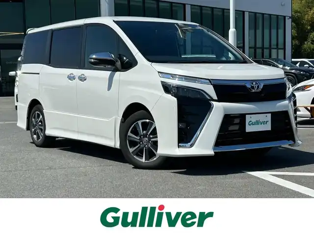 トヨタ ヴォクシー ZS 煌Ⅱ 奈良県 2020(令2)年 3.8万km ホワイトパールクリスタルシャイン ワンオーナー/社外10インチナビ(フルセグTV/AM・FM/CD/DVD/BT/AUX/HDMI)/バックカメラ/両側パワースライドドア/Toyota Safety Sense/プリクラッシュセーフティ/レーンディパーチャーアラート/クルーズコントロール/アイドリングストップ機能/ハーフレザーシート/後席サンシェード/純正フロアマット/純正16インチアルミホイール/スペアキー/フロントオートエアコン（左右独立温度コントロール）/リヤオートエアコン（リヤクーラー＋リヤヒーター）