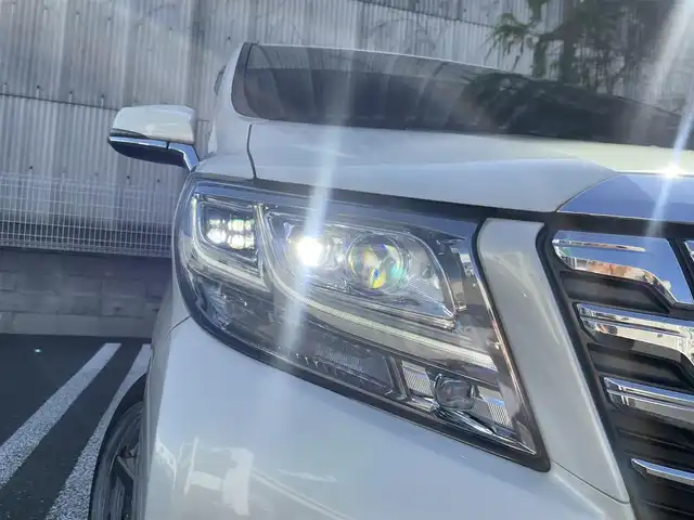 トヨタ アルファード エグゼクティブ ラウンジ 埼玉県 2015(平27)年 13万km ラグジュアリーホワイトパールクリスタルシャインガラスフレーク /4WD//Wサンルーフ//JBL純正10型メモリナビ//フルセグTV//全方位カメラ//フリップダウンモニター//CD/DVD/Bluetooth//黒レザーシート//前2席パワーシート//前2席&2列目シートヒーター//2列目エアシート//助手席&2列目オットマン//両側パワースライドドア//パワーバックドア//アダプティブクルーズコントロール//ビルトインETC//スマートキー//LEDヘッドライト//ステアリングヒーター//PCS衝突軽減ブレーキ//W.サイドエアバッグ//カーテン.ニーエアバッグ//ABS//横滑り防止装置//クリアランスソナー//オートライト/オートハイビーム//スモークフィルム//ドアバイザー//モデリスタエアロ//TEIN車高調//社外21インチAW//新車時保証書//取扱説明書//ナビ取説