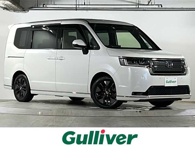 ホンダ ステップワゴン スパーダ eHEV 広島県 2023(令5)年 4.9万km プラチナホワイトパール 禁煙/ホンダセンシング/●衝突軽減ブレーキ（CMBS）/●誤発進抑制機能/●後方誤発進抑制機能/●近距離衝突軽減ブレーキ/●歩行者事故低減ステアリング/●路外逸脱抑制機能/●渋滞追従機能付アダプティブクルーズコントロール（ACC）/●車線維持支援システム（LKAS）/●トラフィックジャムアシスト（渋滞運転支援機能）/●先行車発進お知らせ機能●標識認識機能/●オートハイビーム/●アダプティブドライビングビーム/BSi/コーナーセンサー/純正11.4型ナビ（LXM-237VFi）/・フルセグ/CD/DVD/SD/MusicRack/BT/スマホ連携/バックカメラ/両側パワースライドドア/パワーテールゲート/減速セレクター/電動パーキングブレーキ/オートブレーキホールド/前席シートヒーター/コンビシート/オットマン/LEDアクティブコーナリングライト/フォグランプ/LEDシーケンシャルターンランプ/トリプルゾーンエアコン/スマートキー/プッシュスタート/スペアキー/ETC2.0/ドアバイザー/AC100V100W電源（トランクパネル内）