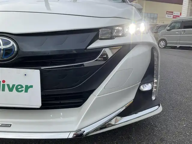 トヨタ プリウス ＰＨＶ S 滋賀県 2017(平29)年 9.4万km ホワイトパールクリスタルシャイン 車検8年6月まで/トヨタセーフティセンス/クルーズコントロール/モデリスタエアロ（フロント、サイド、リア）/純正9インチナビ/Bluetooth、CD、DVD、フルセグテレビ/バックカメラ/ビルトインETC/前席シートヒーター/ステアリングヒーター/純正LEDヘッドライト・LEDフォグランプ/充電ケーブル有り/純正ゴムマット/取扱説明書/保証書