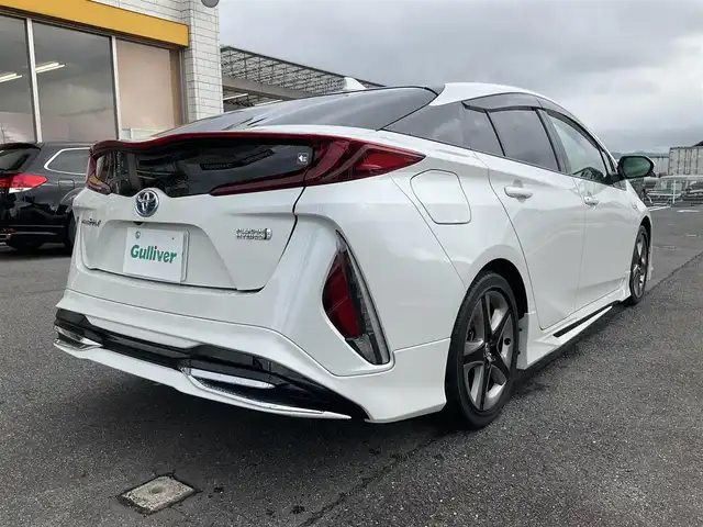 トヨタ プリウス ＰＨＶ S 滋賀県 2017(平29)年 9.4万km ホワイトパールクリスタルシャイン 車検8年6月まで/トヨタセーフティセンス/クルーズコントロール/モデリスタエアロ（フロント、サイド、リア）/純正9インチナビ/Bluetooth、CD、DVD、フルセグテレビ/バックカメラ/ビルトインETC/前席シートヒーター/ステアリングヒーター/純正LEDヘッドライト・LEDフォグランプ/充電ケーブル有り/純正ゴムマット/取扱説明書/保証書