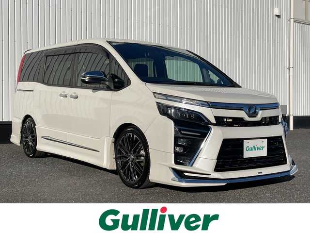 トヨタ ヴォクシー ZS 煌Ⅱ 千葉県 2019(平31)年 3万km ホワイトパールクリスタルシャイン モデリスタエアロ/カロッツェリア10インチナビ/(フルセグTV/BT/CD/DVD/FM/AM)/アルパイン12.8インチフリップダウンモニター/デジタルインナーミラー型前後ドラレコ/TEIN車高調/VALENTIテールランプ/社外エアクリーナー/衝突被害軽減システム/車線逸脱警報/バックカメラ/クルーズコントロール/シートカバー/両側パワースライドドア/横滑り防止装置/アイドリングストップ/LEDヘッドライト/フォグランプ/オートライト/ウィンカーミラー/電動格納ミラー/社外18インチAW/シートリフター/プッシュスタート/スマートキー/フロアマット/スペアキー/取扱説明書