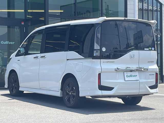 ホンダ ステップワゴン スパーダ ハイブリッド G EX ホンダセンシング 愛媛県 2019(令1)年 6.8万km プラチナホワイトパール 純正9インチナビ（Bluetooth/SD/CD/DVD/AppleCarPlay/AndroidAuto/フルセグTV)/前後ドライブレコーダー/バックカメラ/ビルドインETC/両側パワースライドドア/シートヒーター/ハーフレザーシート/Honda SENSING/・衝突軽減ブレーキ（CMBS）/・誤発進抑制機能/・歩行者事故低減ステアリング/・路外逸脱抑制機能/・渋滞追従機能付アダプティブクルーズコントロール（ACC）/・車線維持支援システム（LKAS）/・先行車発進お知らせ機能/・標識認識機能/・後方誤発進抑制機能/純正16インチアルミホイール/純正フロアマット/ドアバイザー/LEDヘッドライト/フォグランプ/スペアキー1本/スマートキー/取扱説明書/保証書