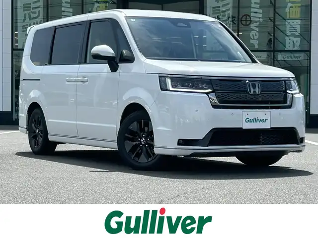 ホンダ ステップワゴン スパーダ eHEV 岡山県 2025(令7)年 0.1千km プラチナホワイトパール 登録時走行距離3km/登録済み未使用車/純正11.4インチナビ/フルセグTV(AM.FM.CD.DVD.TV.BT)/両側パワースライドドア/バックカメラ/ブラインドスポットモニター/シートヒーター/クリアランスソナー/衝突軽減ブレーキ/レーダークルーズコントロール/レーンキープアシスト/オートライト/オートマチックハイビーム/アイドリングストップ/電動リアゲート/16インチ純正AW