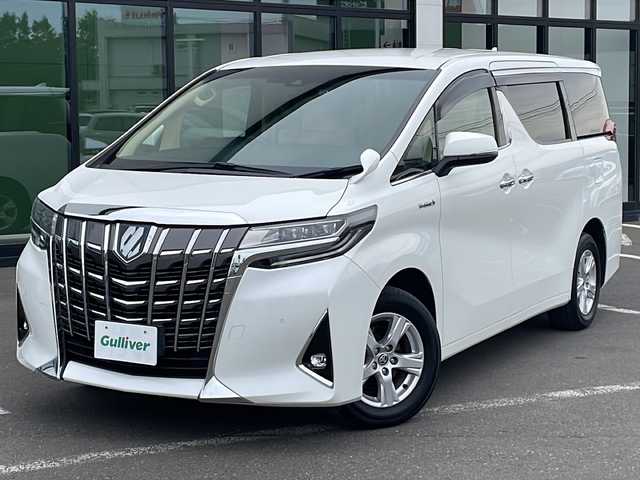 トヨタ アルファードハイブリット X 道東・釧路十勝 2020(令2)年 7.7万km ホワイトパールクリスタルシャイン ・４WD/・純正9インチディスプレイオーディオ/（AM・FM・CD・DVD・USB・BT・フルセグ・Miracast）/・バックカメラ/・純正12.1インチフリップダウンモニター/・両側パワースライドドア/・クルーズコントロール/・社外前後ドライブレコーダー/・白線逸脱防止機能/・オートマチックハイビーム/・オートブレーキホールド/・横滑り防止装置/・セカンドシートオットマン/・革巻きステアリング/・LEDヘッドライト/・LEDフォグライト/・純正フロアマット/・純正ドアバイザー/・ビルトインETC2.0/・純正16インチアルミホイール/・ディーラーオプションスペアタイヤ積み込み/・保証書/・取扱説明書