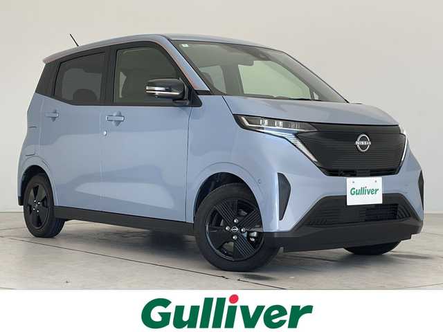 日産 サクラ X 90周年記念車 愛知県 2024(令6)年 0.7万km ライトブルー 純正9型ディスプレイオーディオ　ナビ機能なし/全方位カメラ/バックカメラ/コーナーセンサー/純正アルミホイール/LEDヘッドライト/オートマチックハイビーム/ドライブレコーダー/ETC/ワイヤレス充電機/衝突軽減システム/Bluetooth/ステアリングスイッチ/スマートキー/プッシュスタート