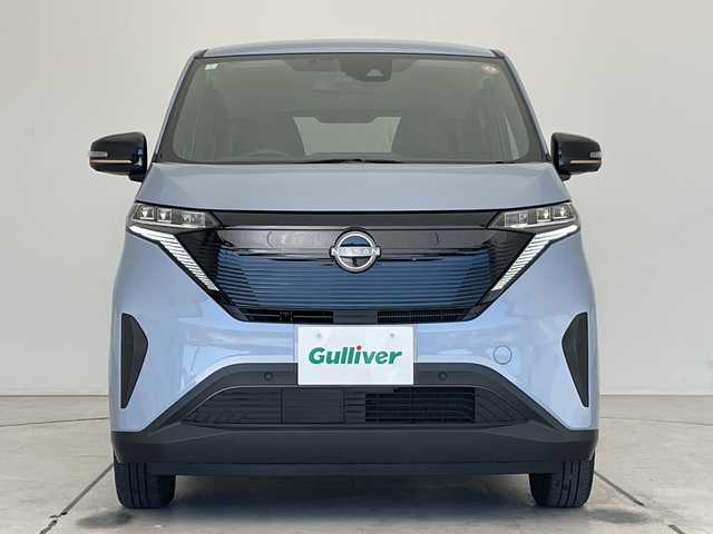 日産 サクラ X 90周年記念車 愛知県 2024(令6)年 0.7万km ライトブルー 純正9型ディスプレイオーディオ　ナビ機能なし/全方位カメラ/バックカメラ/コーナーセンサー/純正アルミホイール/LEDヘッドライト/オートマチックハイビーム/ドライブレコーダー/ETC/ワイヤレス充電機/衝突軽減システム/Bluetooth/ステアリングスイッチ/スマートキー/プッシュスタート