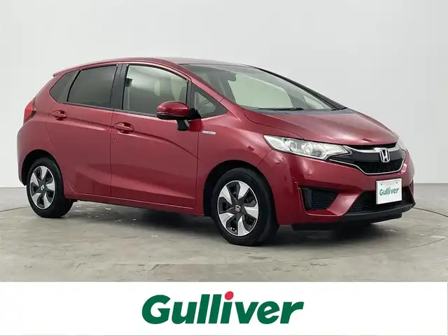 ホンダ フィット ハイブリット Fパッケージ コンフォートED 大分県 2016(平28)年 7.2万km プレミアムクリスタルレッドM ワンオーナー/純正SDナビ（VXM-175VFi）/ BT/CD/DVD/フルセグ/バックカメラ/シートヒーター（前席）/クルーズコントロール/オートライト/アイドリングストップ/ステアリングスイッチ/電動格納ミラー/ビルトインETC/プッシュスタート/スマートキー/純正フロアマット