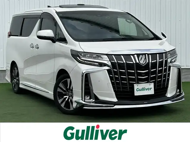 トヨタ アルファード S Cパッケージ 香川県 2019(令1)年 5.1万km ホワイトパールクリスタルシャイン 登録時走行距離：50982km/アルパイン11型ナビ/　CD DVD BT フルセグTV/バックカメラ　左サイドカメラ/アルパインフリップダウンモニター/Wサンルーフ/モデリスタエアロ（フロント　サイド　リアアンダー）/両側パワースライドドア/パワーバックドア/プリクラッシュセーフティシステム/レーンキープアシスト/レーダークルーズコントロール/ブラインドスポットモニター/クリアランスソナー/オートハイビーム/LEDヘッドライト/オートライト/フォグランプ/デジタルインナーミラー/前後ドライブレコーダー/ビルトインETC/レザーシート/シートベンチレーション/パワーシート/シートメモリ/オットマン/ステアリングヒーター/プッシュスタート/スマートキー/スペアキー