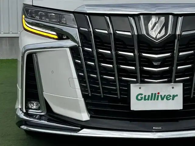 トヨタ アルファード S Cパッケージ 香川県 2019(令1)年 5.1万km ホワイトパールクリスタルシャイン 登録時走行距離：50982km/アルパイン11型ナビ/　CD DVD BT フルセグTV/バックカメラ　左サイドカメラ/アルパインフリップダウンモニター/Wサンルーフ/モデリスタエアロ（フロント　サイド　リアアンダー）/両側パワースライドドア/パワーバックドア/プリクラッシュセーフティシステム/レーンキープアシスト/レーダークルーズコントロール/ブラインドスポットモニター/クリアランスソナー/オートハイビーム/LEDヘッドライト/オートライト/フォグランプ/デジタルインナーミラー/前後ドライブレコーダー/ビルトインETC/レザーシート/シートベンチレーション/パワーシート/シートメモリ/オットマン/ステアリングヒーター/プッシュスタート/スマートキー/スペアキー