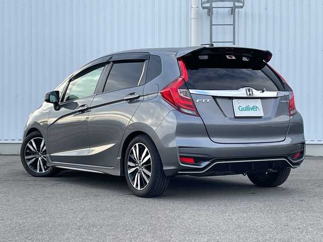 ホンダ フィット ハイブリット S ホンダセンシング 愛媛県 2018(平30)年 7.4万km シャイニンググレーM 純正ナビ/バックカメラ/衝突軽減システム/ビルトインETC/ドライブレコーダー前後/フルセグTV/クルーズコントロール追従あり/オートLED/レーンキープアシスト/横滑り防止装置/純正16AW/純正フロアマット/スペアキー1本/Bluetooth