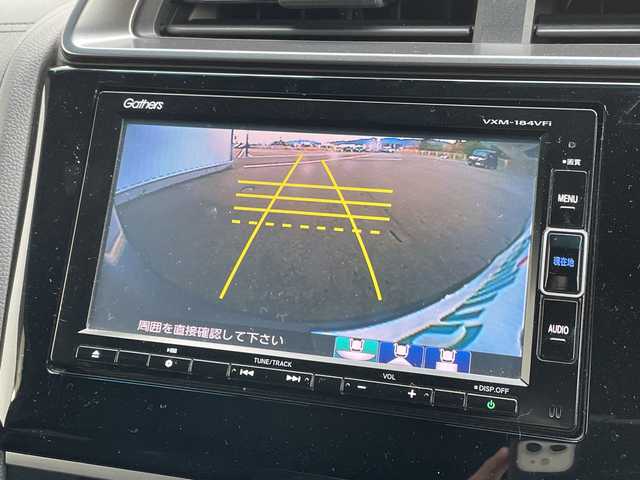 ホンダ フィット ハイブリット S ホンダセンシング 愛媛県 2018(平30)年 7.4万km シャイニンググレーM 純正ナビ/バックカメラ/衝突軽減システム/ビルトインETC/ドライブレコーダー前後/フルセグTV/クルーズコントロール追従あり/オートLED/レーンキープアシスト/横滑り防止装置/純正16AW/純正フロアマット/スペアキー1本/Bluetooth