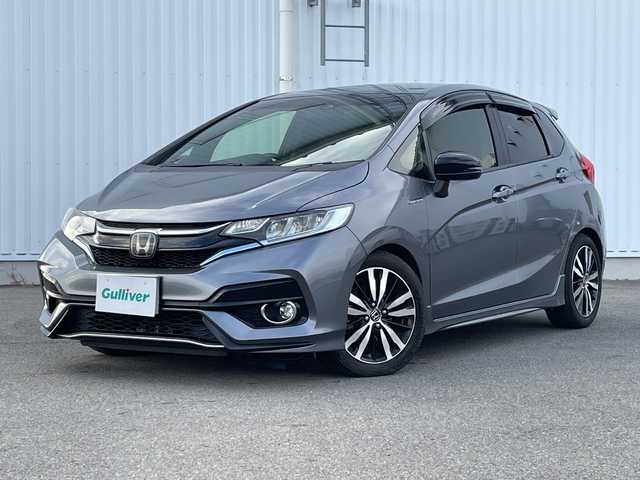 ホンダ フィット ハイブリット S ホンダセンシング 愛媛県 2018(平30)年 7.4万km シャイニンググレーM 純正ナビ/バックカメラ/衝突軽減システム/ビルトインETC/ドライブレコーダー前後/フルセグTV/クルーズコントロール追従あり/オートLED/レーンキープアシスト/横滑り防止装置/純正16AW/純正フロアマット/スペアキー1本/Bluetooth