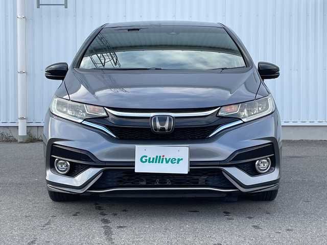 ホンダ フィット ハイブリット S ホンダセンシング 愛媛県 2018(平30)年 7.4万km シャイニンググレーM 純正ナビ/バックカメラ/衝突軽減システム/ビルトインETC/ドライブレコーダー前後/フルセグTV/クルーズコントロール追従あり/オートLED/レーンキープアシスト/横滑り防止装置/純正16AW/純正フロアマット/スペアキー1本/Bluetooth