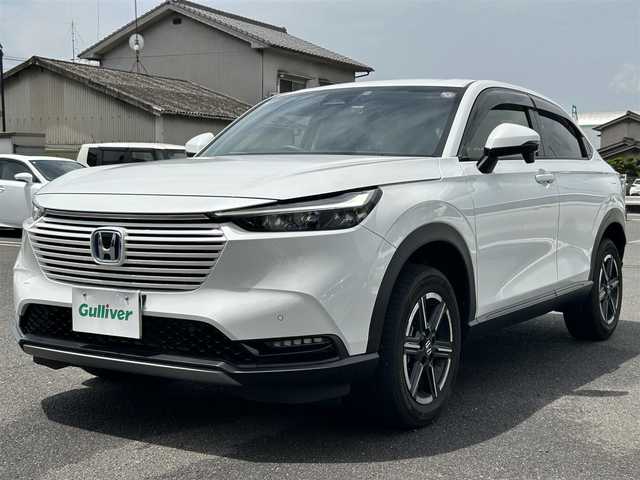 ホンダ ヴェゼル ハイブリッド e:HEV X 広島県 2023(令5)年 1.4万km プラチナホワイトパール ディスプレイオーディオ/（AM/FM/BT/USB）/バックカメラ/レーダークルーズコントロール/レーンキープアシスト/前後コーナーセンサー/衝突被害軽減システム/純正AW16インチ/電子パーキングシステム/前後ドラレコ/LEDライト/LEDフォグ/オートライト/Honda CONNECT for Gathers/ナビ装着用スペシャルパッケージ