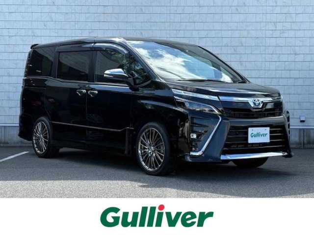 トヨタ ヴォクシー ハイブリッド ZS 煌Ⅲ 大阪府 2021(令3)年 4.4万km イナズマスパーキングブラックガラスフレーク 純正9インチナビ(BT/フルセグ/DVD)/バックカメラ/フリップダウンモニター/衝突被害軽減システム/クルーズコントロール/レーンキープアシスト/コーナーセンサー/両側パワースライドドア/ハーフレザーシート/シートヒーター/ETC/LEDヘッドライト/オートライト/オートマチックハイビーム/ドライブレコーダー/社外フロアマット/社外アルミホイール/スペアキー