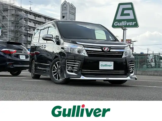 トヨタ ヴォクシー ZS 煌 大分県 2015(平27)年 8.9万km ブラック 純正ナビ（NSZT-W64）/Bluetooth/バックカメラ/フルセグTV/フリップダウンモニター/ビルトインETC/ドライブレコーダー/オートライト/LEDヘッドランプ/純正AW/モデリスタエアロ/社外フロアマット/スマートキー