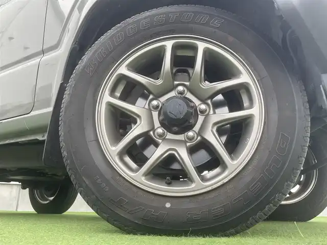 スズキ ジムニー XC 香川県 2019(平31)年 3.9万km ミディアムグレー 社外ＳＤナビ/→フルセグＴＶ/バックカメラ/Bluetooth/CD/社外ショックアムソーバー/社外リアラダー/クルーズコントロール/レーンキープアシスト/衝突軽減システム/横滑り防止機能/ダウンヒルアシストコントロール/アイドリングストップ/パワーステアリング/パワーウィンドウ/エアバック→Ｗ＋サイド/カーテンエアバック/オートエアコン/ETC/シートヒーター/純正ＬＥＤライト/純正アルミホイール/純正フロアマット　/社外ミュージックサーバー（ＳＤなし）　/盗難防止車/プッシュスタート/スマートキー/オートマチックハイビーム/オートライト/アシストミラー/スペアキー1本/背面タイヤ