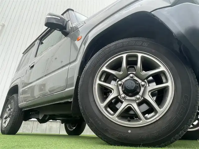 スズキ ジムニー XC 香川県 2019(平31)年 3.9万km ミディアムグレー 社外ＳＤナビ/→フルセグＴＶ/バックカメラ/Bluetooth/CD/社外ショックアムソーバー/社外リアラダー/クルーズコントロール/レーンキープアシスト/衝突軽減システム/横滑り防止機能/ダウンヒルアシストコントロール/アイドリングストップ/パワーステアリング/パワーウィンドウ/エアバック→Ｗ＋サイド/カーテンエアバック/オートエアコン/ETC/シートヒーター/純正ＬＥＤライト/純正アルミホイール/純正フロアマット　/社外ミュージックサーバー（ＳＤなし）　/盗難防止車/プッシュスタート/スマートキー/オートマチックハイビーム/オートライト/アシストミラー/スペアキー1本/背面タイヤ
