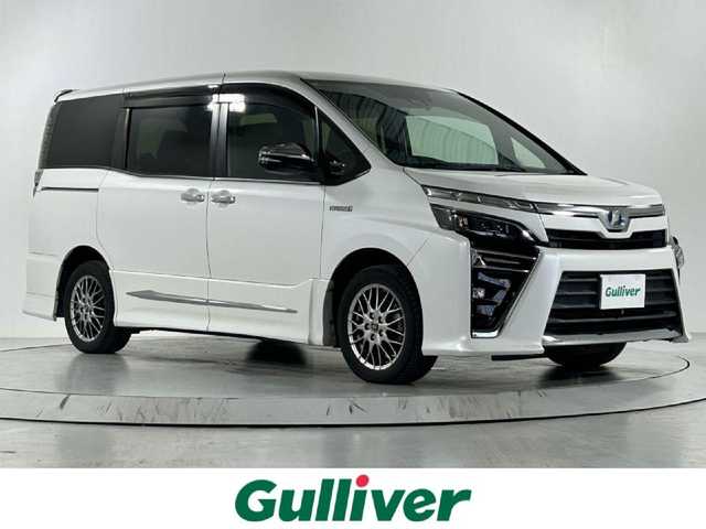 トヨタ ヴォクシー ハイブリッド ZS 煌 佐賀県 2018(平30)年 14.1万km ホワイトパールクリスタルシャイン アルパイン１１インチナビ　/アルパインフリップダウンモニター　/両側パワースライドドア　/衝突被害軽減装置　/レーンキープアシスト　/オートマチックハイビーム/バックカメラ　/フルセグテレビ　/ビルトインＥＴＣ　/クルーズコントロール/純正16インチアルミホイール/LEDヘッドライト/スマートキー