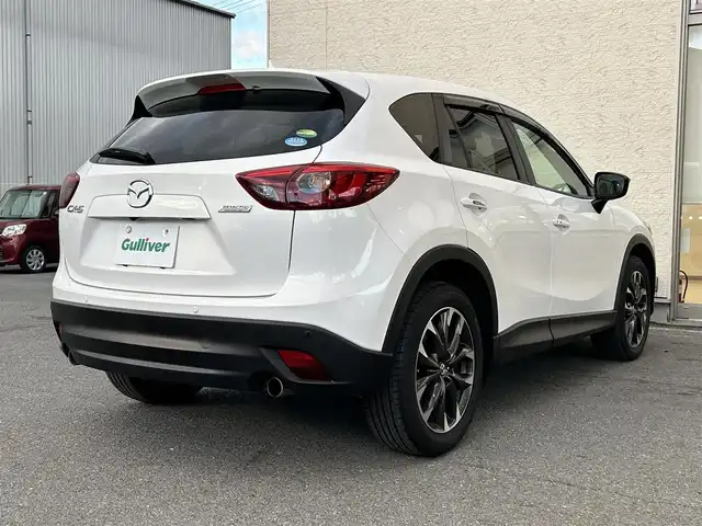 マツダ ＣＸ－５ 25S Lパッケージ 大阪府 2015(平27)年 5.3万km クリスタルホワイトパールマイカ ワンオーナー/革シート/前席パワーシート/前席シートヒーター/SDナビ フルセグTV CD DVD BT/バックカメラ/衝突被害軽減ブレーキ/レーダークルーズコントロール/レーンアシスト/ブラインドスポットモニタ/オートマチックハイビーム/LEDオートヘッドライト/フォグライト/スマートキー2個/バックソナー/ドラレコ/ETC/19インチアルミホイール/横滑り防止/ステアリングリモコン/W サイド カーテン エアバッグ/保証書 取説/禁煙車