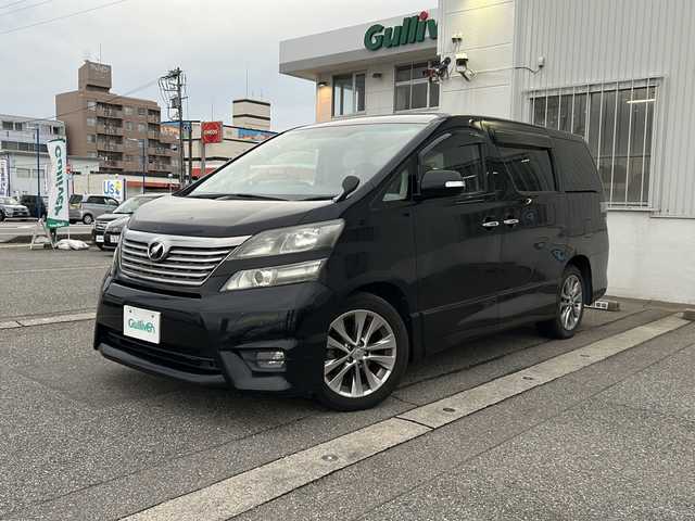 トヨタ ヴェルファイア 2．4Z プラチナセレクションⅡ 富山県 2011(平23)年 9.8万km ブラック ワンオーナー/４WD/両側パワースライドドア/スマートキー/純正メモリーナビ（NSZT-W60）/純正フリップダウンモニター/DVD/MSV/フルセグTV/バックカメラ/ビルトインETC/前後ドラレコ/純正１８インチAW/HIDヘッドライト/フォグ/クリアランスソナー/オットマンシート/電格ウィンカーミラー/木目・革巻きステアリング/ステアリングスイッチ/純正ドアバイザー/純正フロアマット/プッシュスタート/保証書・取説