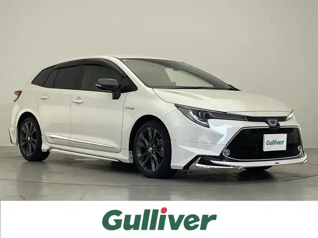 トヨタ カローラツーリング ハイブリッド ダブルバイビー 滋賀県 2020(令2)年 1.6万km ホワイトパールクリスタルシャイン 禁煙車/純正9インチナビ/・フルセグTV・Bluetooth・Miracast・AM・FM/モデリスタエアロ/バックカメラ/ビルトインETC/前後ドライブレコーダー/電動パーキングブレーキ/ブレーキホールド/レーダークルーズコントロール/ハーフレザーシート/ハーフレザーシート/横滑り防止機能/オートハイビーム/ブラインドスポットモニター/純正フロアマット/純正17インチアルミホイール