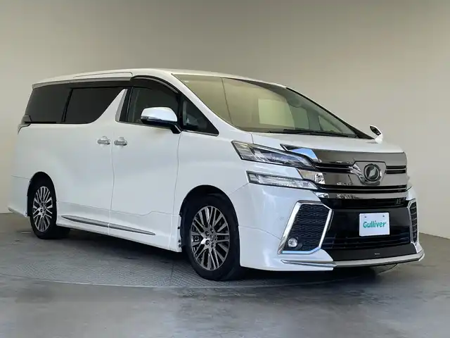 トヨタ ヴェルファイア Z Gエディション 栃木県 2016(平28)年 13万km ホワイトパールクリスタルシャイン 純正ナビ/(CD/DVD/Bluetooth/フルセグTV/MSV/SD)/バックカメラ/モデリスタフルエアロ/コーナーセンサー/衝突軽減ブレーキ/ビルトインETC/前後ドラレコ/パワーシート/両側パワースライドドア/パワーバックドア/ハーフレザーシート/メモリーシート/禁煙車/デジタルインナーミラー/ステアリングヒーター/後席モニター/オートライト/LEDヘッドライト/横滑り防止装置/フォグランプ/スマートキー/プッシュスタート/ステアリングスイッチ/革巻きステアリング/ウィンカーミラー/電動格納ミラー/純正18インチアルミホイール/純正フロアマット