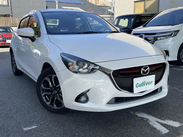 マツダ デミオ XD ミッドセンチュリー 福岡県 2015(平27)年 11.3万km スノーフレイクホワイトパールマイカ 純正メーカーナビ/（AM/FM/CD/DVD/USB/AUX/Bluetooth/フルセグTV）/パドルシフト/クルーズコントロール/横滑り防止/レーンキープ/アイドリングストップ/衝突軽減ブレーキ/シートヒーター（運転席/助手席）/ハンズフリー/オートライト/フォグランプ/電格ミラー/純正フロアマット/純正アルミホイール/ETC/ドライブレコーダー前/保証書/取扱説明書/スペアキー×１