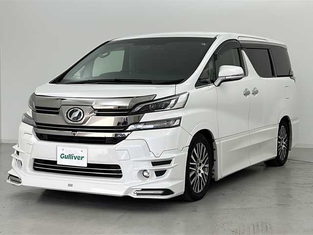 トヨタ ヴェルファイア ZA Gエディション 宮城県 2016(平28)年 3.2万km ホワイトパールクリスタルシャイン TRDエアロ（FSR）/TRDマフラー/JBLサウンド/4WD/全周囲カメラ/プリクラッシュセーフティー/レーダークルーズコントロール/オートハイビーム/メーカーOPナビ/・BT.CD.DVD.USB.SD/ワンセグTV/純正フリップダウンモニター/電動リアゲート/両側パワースライドドア/ハーフレザーシート/全席パワーシート/オットマン/ウッドコンビステアリング/ステアリングヒーター/ステアリングスイッチ/ビルトインETC/ドライブレコーダー（F）/プッシュスタート/スマートキー×2/電動パーキングブレーキ/LEDヘッドライト/LEDフォグライト/純正18インチAW/純正フロアマット/ドアバイザー/ロールサンシェード