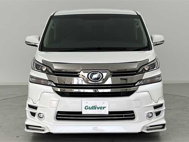 トヨタ ヴェルファイア ZA Gエディション 宮城県 2016(平28)年 3.2万km ホワイトパールクリスタルシャイン TRDエアロ（FSR）/TRDマフラー/JBLサウンド/4WD/全周囲カメラ/プリクラッシュセーフティー/レーダークルーズコントロール/オートハイビーム/メーカーOPナビ/・BT.CD.DVD.USB.SD/ワンセグTV/純正フリップダウンモニター/電動リアゲート/両側パワースライドドア/ハーフレザーシート/全席パワーシート/オットマン/ウッドコンビステアリング/ステアリングヒーター/ステアリングスイッチ/ビルトインETC/ドライブレコーダー（F）/プッシュスタート/スマートキー×2/電動パーキングブレーキ/LEDヘッドライト/LEDフォグライト/純正18インチAW/純正フロアマット/ドアバイザー/ロールサンシェード