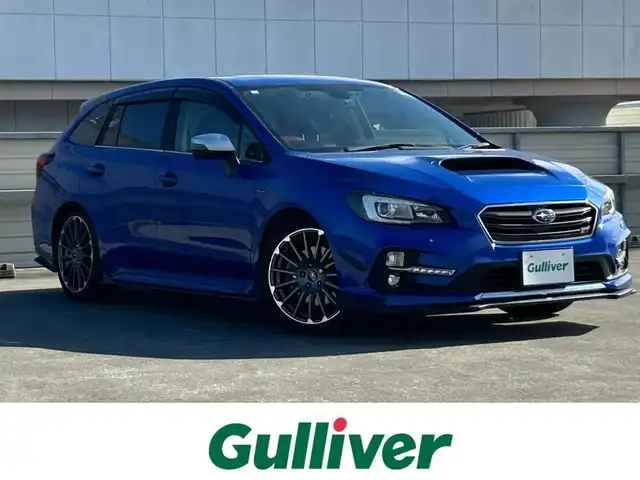 スバル レヴォーグ 2．0STIスポーツアイサイト 静岡県 2016(平28)年 9.8万km WRブルーパール 純正ディーラーナビ/４WD/フルセグTV/Bluetooth・AM・FM/CD・DVD/アドバンスドパッケージ/ガナドールマフラー/サンルーフ/赤黒レザーシート/運転席シートメモリ/前席パワーシート・シートヒーター/アイサイトver3/ブラインドスポットモニター/衝突軽減ブレーキ/追従クルーズコントロール/アクティブレーンキープ/ハイビームアシスト/リアビークルディテクション/ビルトインETC/フロント・リアUSB電源/LEDヘッドライト/LEDフォグランプ/LEDアクセサリーライナー/純正18インチアルミ/社外スタッドレスタイヤ・ホイール車載/ASSURAレーダー/ドライブレコーダー/革巻きステアリング/純正ドアバイザー/保証書・取説・スペアキー