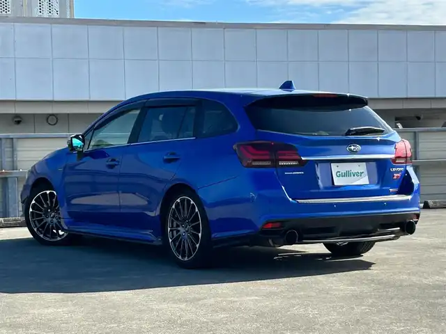 スバル レヴォーグ 2．0STIスポーツアイサイト 静岡県 2016(平28)年 9.8万km WRブルーパール 純正ディーラーナビ/４WD/フルセグTV/Bluetooth・AM・FM/CD・DVD/アドバンスドパッケージ/ガナドールマフラー/サンルーフ/赤黒レザーシート/運転席シートメモリ/前席パワーシート・シートヒーター/アイサイトver3/ブラインドスポットモニター/衝突軽減ブレーキ/追従クルーズコントロール/アクティブレーンキープ/ハイビームアシスト/リアビークルディテクション/ビルトインETC/フロント・リアUSB電源/LEDヘッドライト/LEDフォグランプ/LEDアクセサリーライナー/純正18インチアルミ/社外スタッドレスタイヤ・ホイール車載/ASSURAレーダー/ドライブレコーダー/革巻きステアリング/純正ドアバイザー/保証書・取説・スペアキー
