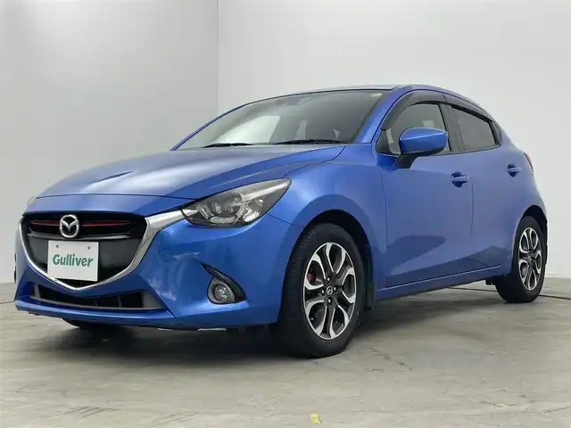 マツダ デミオ XD ツーリング 岡山県 2015(平27)年 9.4万km ダイナミックブルーマイカ クルーズコントロール/純正7インチナビ/（ＣＤ/ＤＶＤ/ＢＴ/フルセグＴＶ）/衝突軽減ブレーキ/ビルトインＥＴＣ/ＬＥＤヘッドライト/バックカメラ/オートハイビーム/オートライト/フォグランプ/プッシュスタート/パドルシフト/純正フロアマット/ＵＳＢ接続/アイドリングストップ/取扱説明書