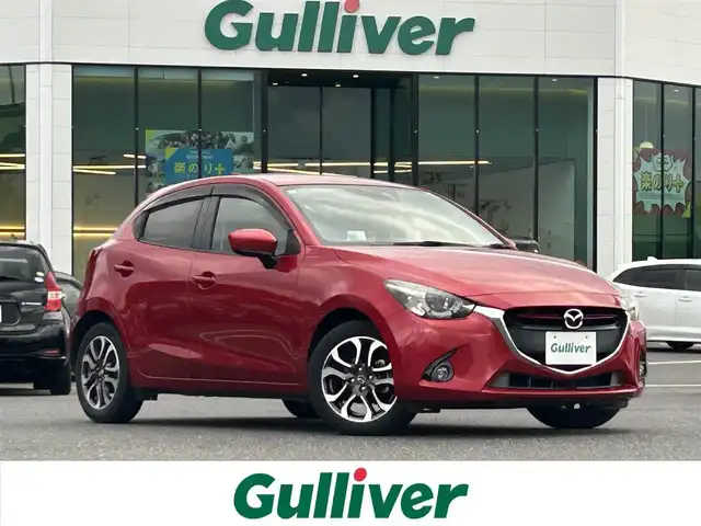 マツダ デミオ XD ツーリング 島根県 2016(平28)年 8.2万km ソウルレッドプレミアムメタリック 登録時走行距離81137km/ワンオーナー/純正ナビ(Bluetooth・AM・FM・CD・DVD)/フルセグテレビ/前席シートヒーター/パドルシフト/クルーズコントロール/スマートシティブレーキサポート/ヘッドアップディスプレイ/ステアリングスイッチ/純正16インチAW/純正フロアマット/i-stop/ETC/オートライト/LEDヘッドライト/フォグランプ/ドアバイザー/プッシュスタート/スマートキー/禁煙車