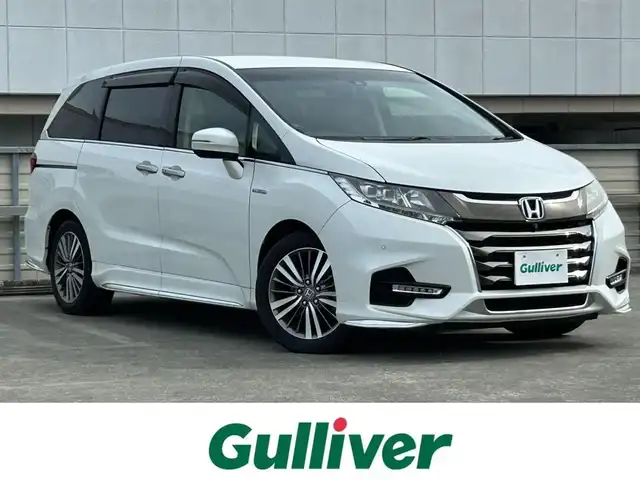 ホンダ オデッセイ ハイブリッド アブソルート・EXホンダセンジング 静岡県 2019(平31)年 3.1万km パール ホンダセンシング/・VSA（ABS＋TCS＋横すべり抑制）/純正7インチナビ/（CD/DVD/Bluetooth/FM/AM/SD）/マルチビューモニター/ETC2.0/カーテンエアバッグ/後席モニター/オートライト/オットマン/キャプテンシート/Wオートエアコン/デュアルエアコン/純正17AW