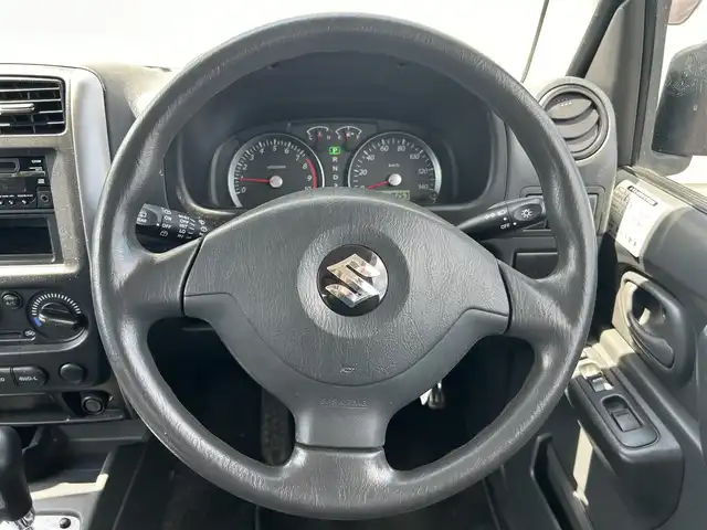 スズキ ジムニー XG 富山県 2013(平25)年 1.9万km シルキーシルバーメタリック ワンオーナー/4WD/IC付きターボ/禁煙車/AUX/背面タイヤ　カバー付き/純正フロアマット/スペアキー１本/アイソフィクス/リアウインドウ・デフォッガー/保証書
