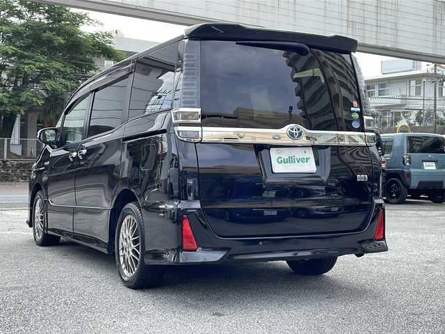 トヨタ ヴォクシー ハイブリッド ZS 煌Ⅱ 沖縄県 2019(令1)年 10.6万km ブラック 純正ナビ/（ＡＭ／ＦＭ／ＣＤ／ＤＶＤ／ＢＴ）　/フルセグＴＶ　/衝突軽減装置　/横滑り防止装置　/盗難防止装置/レーンキープアシスト/前後コーナーセンサー　/両側パワースライドドア　/後席フリップダウンモニター　/ウォークスルー/ドライブレコーダー/スマートキー/プッシュスタート/クルーズコントロール　/バックカメラ/オートヘッドライト/LEDヘッドライト/シートカバー