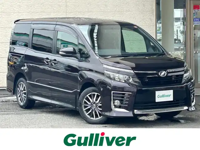 トヨタ ヴォクシー ZS 兵庫県 2014(平26)年 10.8万km ボルドーマイカメタリック 純正ナビ(AM/FM/CD/DVD/TV/BT)/バックカメラ/アイドリングストップ/革巻きステアリング/ステアリングリモコン/プッシュスタート/ビルドインETC/前方ドライブレコーダー/両側パワースライドドア/三列シート/純正フロアマット/ドアバイザー/LEDヘッドライト/純正19インチアルミホイール/スマートキー/保証書/取扱説明書