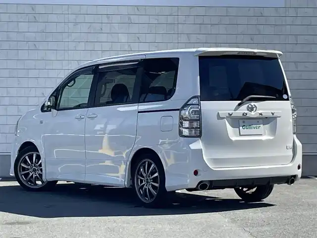 トヨタ ヴォクシー 愛知県 2013(平25)年 7.7万km ホワイトパールクリスタルシャイン G’s純正ローダウン/純正SDメモリーナビ/バックカメラ/フルセグTV/CD/DVD再生/ETC/Bluetooth再生/MTモード付AT/リヤクーラー/3列シート/両側パワースライドドア/純正フロアマット/ウォークスルー(1列目)/社外製18インチアルミホイール/純正HIDヘッドライト/オートライト/横滑り防止装置/電動格納ミラー/ユピテル製ドライブレコーダー(前)/スマートキー/プッシュスタート