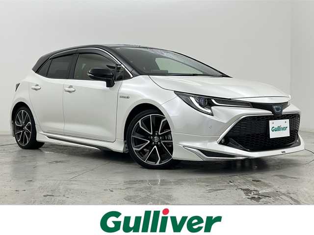 トヨタ カローラ スポーツ ハイブリッドG Z 宮城県 2020(令2)年 6万km アティチュードブラックマイカ/ホワイトパールクリスタルシャイン 禁煙車/モデリスタエアロ（F.S.R）/トヨタセーフティーセンス/・プリクラッシュセーフティーシステム/・レーダークルーズコントロール/・レーントレーシングアシスト/・オートマチックハイビーム/・パーキングサポートブレーキ/・ロードサインアシスト/・ソナー/ヘッドアップディスプレイ/前席シートヒーター/赤革スエードコンビシート/純正9インチディスプレイオーディオ/・BT.AM.FM.USB.Miracast/バックカメラ/フルセグテレビ/電動パーキングブレーキ/AUTOHOLD/ビルトインETC/プッシュスタート/スマートキー/革巻きステアリング/ステアリングスイッチ/純正フロアマット/純正ドアバイザー/純正18インチアルミホイール/LEDヘッドライト/LEDフォグランプ/横滑り防止機能/アイドリングストップ/ヘッドライトレベライザー