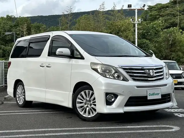 トヨタ アルファード 240S 長崎県 2012(平24)年 9.5万km ホワイトパールクリスタルシャイン 純正アルファード専用ナビ(FM/AM/CD/DVD/BT/TV)/プッシュスタート/スマートキー/ビルトインETC/純正フロアマット/純正アルミホイール/MTモード付AT/レザーシート/2列目オットマン/3列シート/後席用モニター/両側イージークローザードア/バックカメラ/オートライト/ABS/横滑り防止装置(VSC)/盗難防止装置/取扱説明書/記録簿/保証書