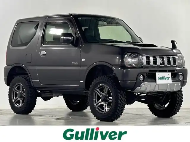 スズキ ジムニー クロスアドベンチャー 佐賀県 2012(平24)年 8.1万km クエーサーグレーメタリック タイヤサイズ195R16C 104/102Q 6PR /２インチリフトUP/社外サスペンション＆ショックアブソーバー/調整式ラテラルロッド/社外7インチメモリーナビ【CN-E202Z】/ワンセグTV/CD/純正１６インチアルミホイール/運転席シートヒーター/合皮シート/フォグライト/キーレス/スペアキー×１/電動格納ミラー/フロアマット/HITACHI製タービン/サイドアンダーミラー/ドアバイザー