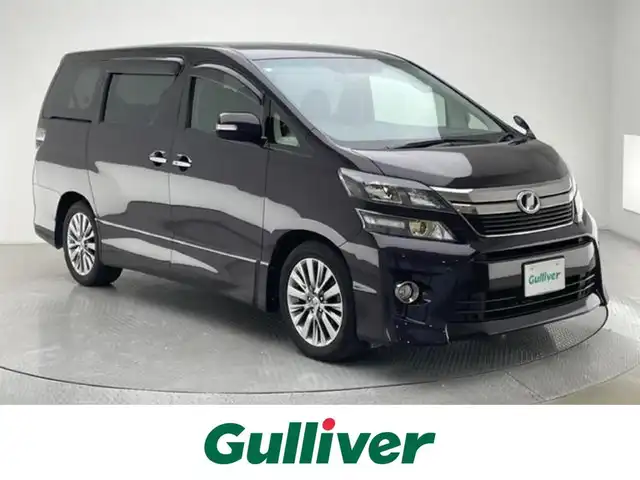 トヨタ ヴェルファイア 2．4Z ゴールデンアイズⅡ 兵庫県 2014(平26)年 7.7万km ボルドーマイカメタリック 社外SDナビ/（AM/FM/CD/DVD/Bluetooth/フルセグTV）/・NSZT-W64G/バックカメラ/クルーズコントロール/くクリアランスソナー/横滑り防止装置/カーテンエアバッグ/コーナーセンサー（前後）/パワーバックドア/両側パワースライドドア/フリップダウンモニター/オートライト/ビルトインETC/純正18インチアルミホイール/純正フロアマット/ドアバイザー/スマートキー/スペアキー1本