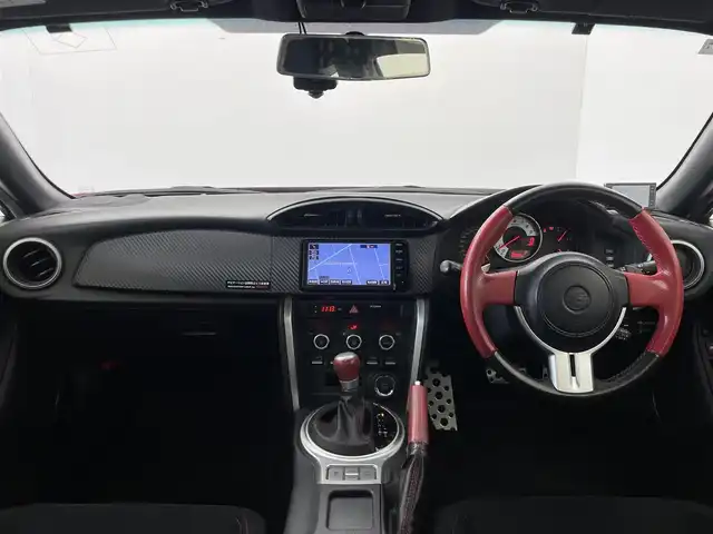 トヨタ ８６ GT 群馬県 2015(平27)年 7万km ピュアレッド tom’sテールライト/純正リアバンパーガーニッシュカバー/社外トランクスポイラー/社外グリル/＝＝＝＝＝/純正7インチSDナビ/・BT TV AM FM SD DISC AUX/=====/クルーズコントロール　パドルシフト　ワンオーナー　純正７インチＳＤナビ　ｔｏｍ｀ｓテールライト　純正リアバンパーガーニッシュカバー　社外トランクスポイラー　社外グリル　ＭＴモード付ＡＴ　禁煙車　ＥＴＣ