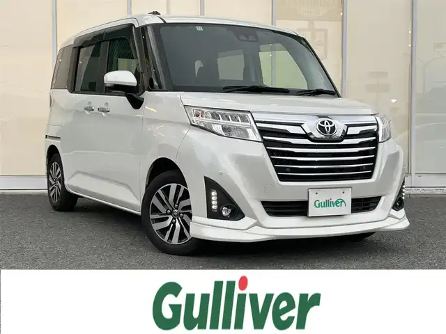 トヨタ ルーミー カスタムG 福岡県 2019(令1)年 2万km パールホワイトⅢ ・ECLIPSEナビ（フルセグ・DVD・CD・Bluetooth）/・バックカメラ/・両側パワースライドドア/・純正ドライブレコーダー（取扱説明書あり）/・ETC/・クルーズコントロール/・トヨタクリアランスソナー/・横滑り防止装置/・オートマチックハイビーム/・衝突軽減システム/・D/N席シートヒーター/・リヤシート格納/・シートバックテーブル（D/N席）/・電動格納ミラー/・純正サンシェード/・純正ドアバイザー/・ISOFIX/・取扱説明書/・保証書