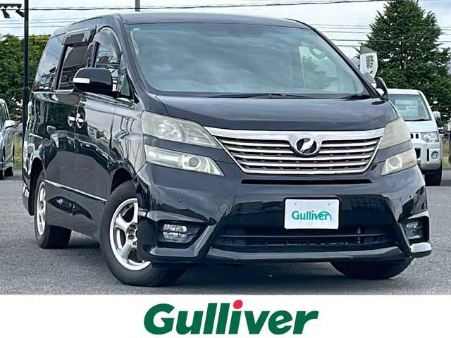 トヨタ ヴェルファイア 2．4Z プラチナセレクションⅡ 道央・札幌 2010(平22)年 15.4万km ブラック ４WD/純正メーカーナビ/CD/DVD/BT/フルセグ/純正フリップダウンモニター/横滑り防止装置/クリアランスソナー/バックカメラ/ビルトインETC/センターデフロック/両側パワースライドドア/パワーバックドア/2列目オットマン/革巻きウッドコンビステアリング/ステアリングリモコン/AC100V/MTモード付AT/プッシュスタート/スマートキー/HIDヘッドライト/オートライト/フォグランプ/電動格納ミラー/ウィンカーミラー/純正フロアマット/ドアバイザー/純正AW付夏タイヤ積込/235/50/R18/2018年/山5mm