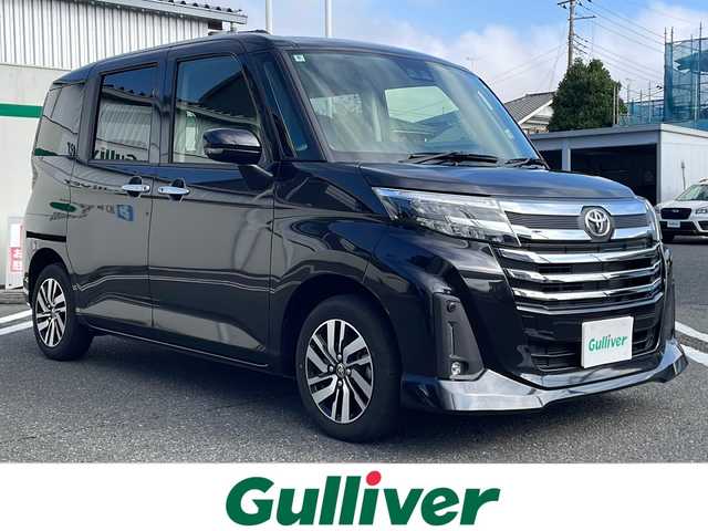 トヨタ ルーミー カスタムG 東京都 2024(令6)年 0.8万km ブラックマイカメタリック ワンオーナー/純正9インチフルセグTVディスプレイオーディオ/(Bluetooth/USB/iPod)/純正14インチアルミホイール/両側パワースライドドア/追従型クルーズコントロール/アイドリングストップ/横滑り防止装置/オートライト/スマートキー/スペアキー1本/取説書/保証書